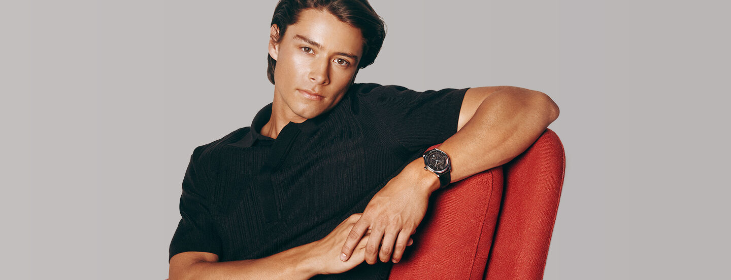 Image of a man sitting on a sofa wearing Classics Runabout Automatic watch model FC-350RBR5B6